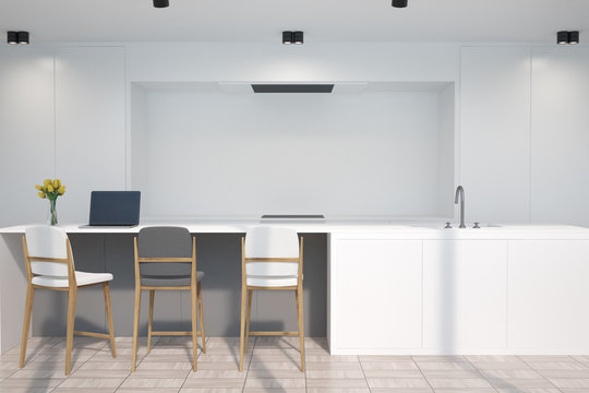 White kitchen with a bar, a gray stool