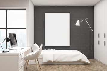 Gray brick bedroom, computer and poster
