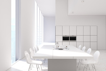 Obraz na płótnie Canvas White kitchen with a table, ovens close up