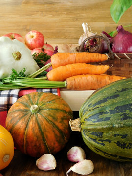 Freshly picked harvest of different autumn vegetables and fruit on a wooden background. Autumn harvest