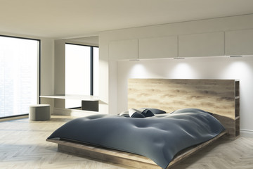 White bedroom with a blue bed