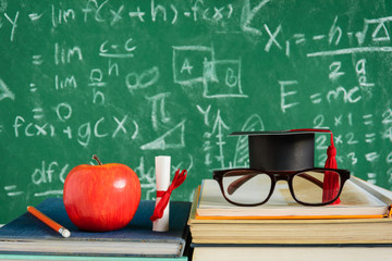 Apple Knowledge Symbol and Pencil Books on the desk with board background.Education concept school