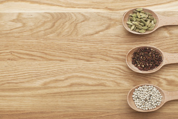 Wooden slices with spices on a wooden board
