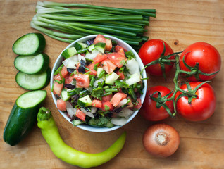 tomato cucumber  pepper salad on desk