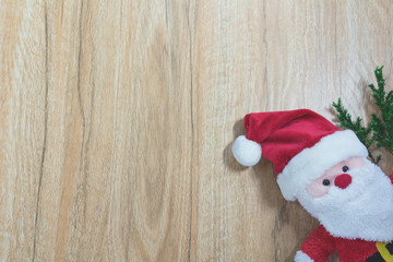 Obraz na płótnie Canvas Santa Claus doll in Christmas day on wooden background with copy space