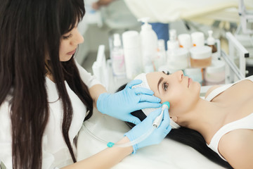 Obraz na płótnie Canvas Body Care. Woman Receiving Face Skin Analysis. Cosmetology