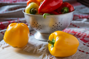 Colored Peppers on a raw surface