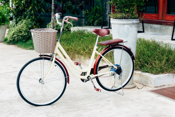 Fototapeta premium Old Ancient Bike On House Wall At Sunset,Copy Space for Text. (Vintage Style)