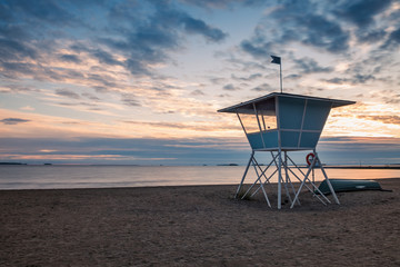 Fototapeta na wymiar Lifeguard Tower on the Beach at Sunset during the Summer in Finland