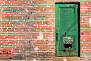 green dorr in a red brick building