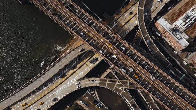 Aerial top view of traffic road in New York, America. Drone flying over traffic intersection on shore of East river.