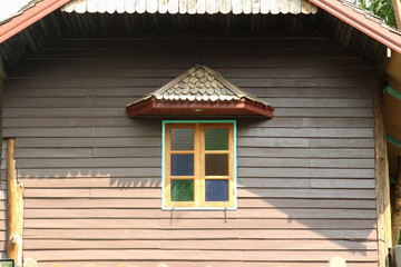 Fototapeta na wymiar Wooden window on wooden house wall.