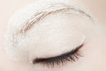 Woman eye with white make up and black eyeliner