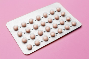 Blister with contraceptive pills on color background
