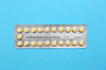 Blister with contraceptive pills on color background
