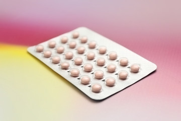 Blister with contraceptive pills on color background