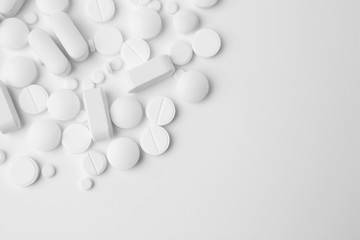 Pile of different pills on white background
