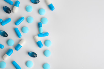 Blue pills on white background