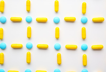 Different colorful pills on white background