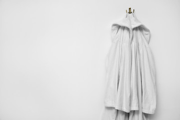Fototapeta premium Bathrobes hanging on white wall