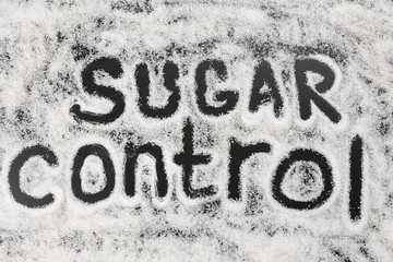 Composition with words Sugar Control on black background. Diabetes concept