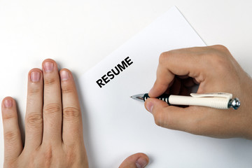 Man's hands on resume form and pen