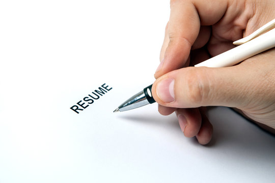 Man's hand on resume form and pen