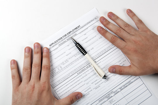 human hand and the form of the document application for employment