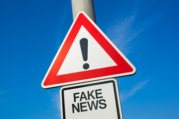 Fake News  - traffic sign with exclamation mark to alert, warn caution - precaution and warning of...