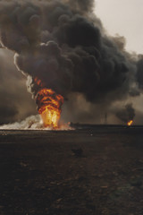 Burning oil well fires in field with oil slick, Kuwait