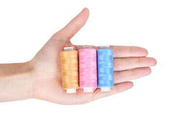 spool of thread in hand isolated on white background