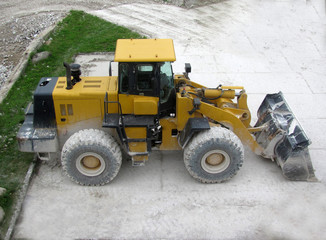 Wheel loader stands near the quarry, top view, the day off