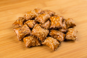 Pile of peanut butter filled pretzels on a wood background