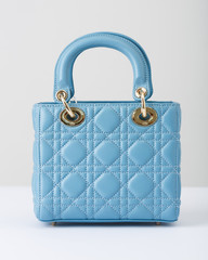 The blue bag with short handle