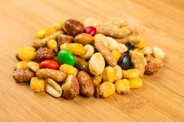 Pile of spiced crunch and candy mix on a wood background