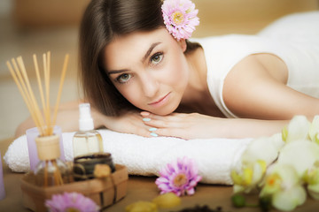 Obraz na płótnie Canvas Young beautiful woman on the spa. Aroma oil and butter. Nice look. The concept of health and beauty. Better In the spa salon.