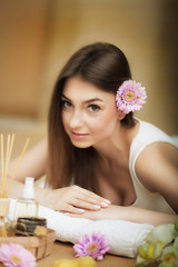 Portrait of a beautiful woman. Skin Care. Spa treatments. Flower in hair. The concept of beauty and health. In the massage salon.