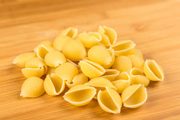 Pile of shell pasta on a wood background