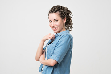 Woman smiling with perfect smile and white teeth. Her hair made in pigtails.
