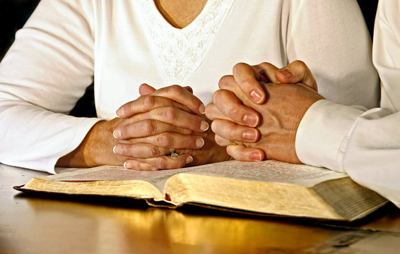 Couple Praying with Holy Bible