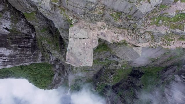 Helicopter shot amazing beautiful view of the cliffs. Tourists enjoy the scenery mountains in the fog and sea. Norway. Europe. Preikestolen Landscape, Prekestolen, Preacher's Pulpit or Pulpit Rock.