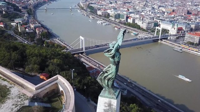 Aerial footage by the liberty statue of Budapest, Hungary, with a general view the city.