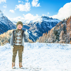 girl against winter mountain landscape showing thumbs up