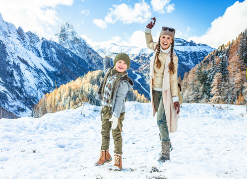 mother and daughter travellers playing snowballs