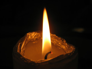 close up of a candle on black background