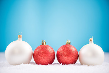 Christmas ball ornaments in defocused snow