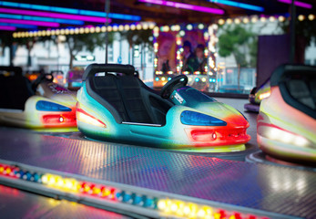 Colorful electric bumper car in amusement park.