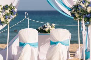 Setting up a wedding on the beach.