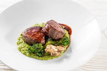 Grilled steak delicious beef meat on a white plate on a light background menu