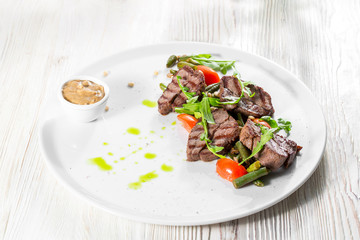 Grilled steak delicious beef meat on a white plate on a light background menu